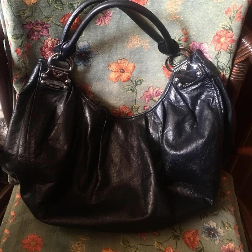 Miu Miu Black Hobo Bag (Category: Luxury Bags & Wallets) located in Manila. Submitted by mariantim76369 (Listing ID 1422409792, Image 2). Description: ⭕️Personal bag. NOT UKAY SOURCE⭕️ - Black Miu Miu hobo bag - Large, slouchy design - Single shoulder strap - Silver-tone hardware - Miu Miu logo on exterior and interior - Dark fabric lining.