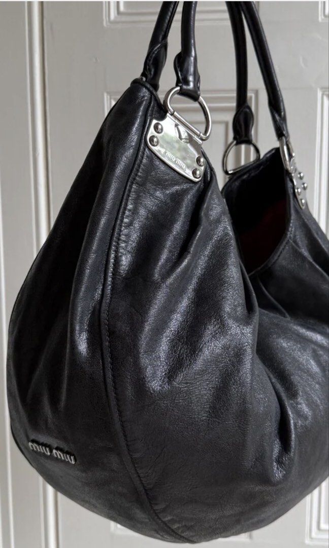 Miu Miu Black Hobo Bag (Category: Luxury Bags & Wallets) located in Manila. Submitted by mariantim76369 (Listing ID 1422409792, Image 1). Description: ⭕️Personal bag. NOT UKAY SOURCE⭕️ - Black Miu Miu hobo bag - Large, slouchy design - Single shoulder strap - Silver-tone hardware - Miu Miu logo on exterior and interior - Dark fabric lining.