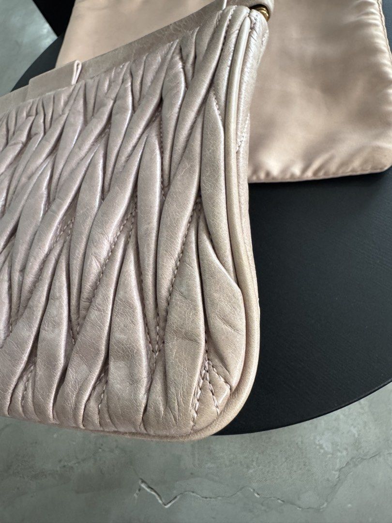 Miu Miu Matelassé Clutch (Category: Clutches) located in Caloocan City. Submitted by gooddayzzph (Listing ID 1422421263, Image 3). Description: - Authentic Miu Miu clutch - Distinctive matelassé design - Gold-tone logo detail - Satin-like interior lining - Includes dust bag - Interior tag: '197'.