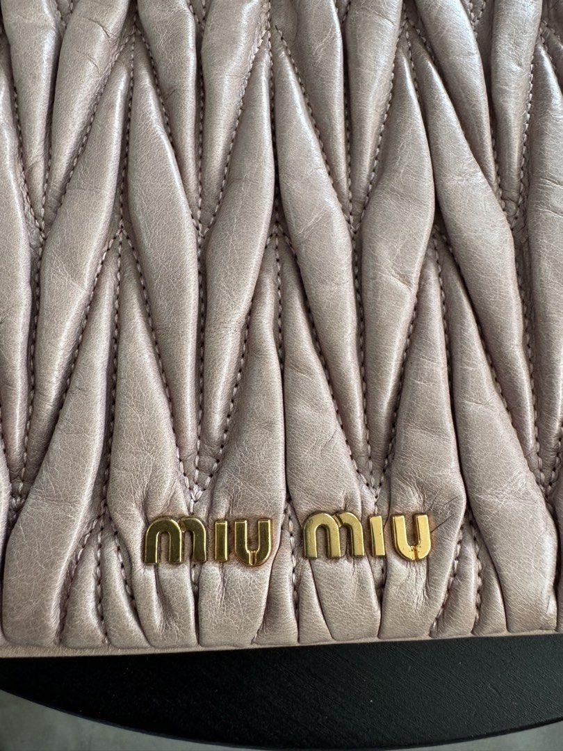 Miu Miu Matelassé Clutch (Category: Clutches) located in Caloocan City. Submitted by gooddayzzph (Listing ID 1422421263, Image 2). Description: - Authentic Miu Miu clutch - Distinctive matelassé design - Gold-tone logo detail - Satin-like interior lining - Includes dust bag - Interior tag: '197'.