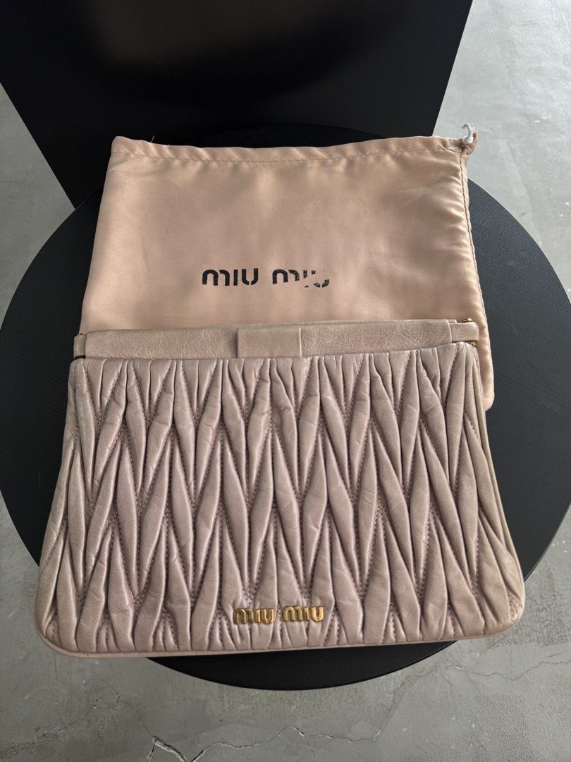 Miu Miu Matelassé Clutch (Category: Clutches) located in Caloocan City. Submitted by gooddayzzph (Listing ID 1422421263, Image 1). Description: - Authentic Miu Miu clutch - Distinctive matelassé design - Gold-tone logo detail - Satin-like interior lining - Includes dust bag - Interior tag: '197'.