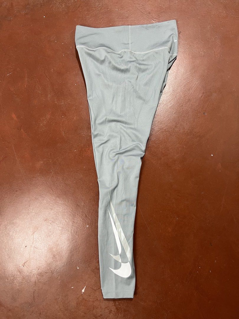 Nike Dri-FIT Leggings - Gray (Category: Activewear) located in Silay City. Submitted by jeffreyxsummer (Listing ID 1422416332, Image 1). Description: Gray Nike Dri-FIT leggings. Features the Nike swoosh logo on the leg. Includes a small pocket. Size M. Made in Vietnam. The leggings have a high waistband and are designed for comfort and performance. Perfect for workouts or casual wear..