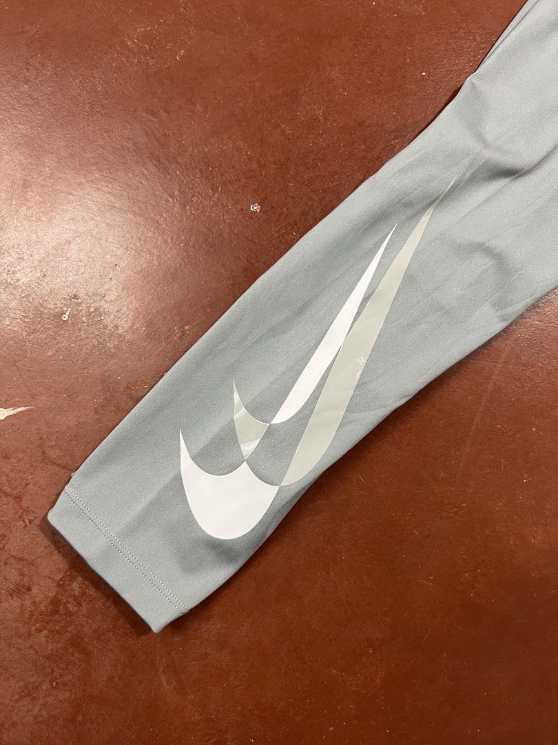 Nike Dri-FIT Leggings - Gray (Category: Activewear) located in Silay City. Submitted by jeffreyxsummer (Listing ID 1422416332, Image 2). Description: Gray Nike Dri-FIT leggings. Features the Nike swoosh logo on the leg. Includes a small pocket. Size M. Made in Vietnam. The leggings have a high waistband and are designed for comfort and performance. Perfect for workouts or casual wear..