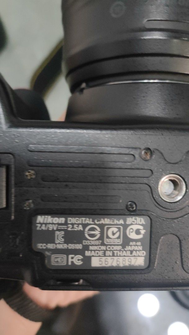 50mm Nikon D5100 DSLR Camera and Accessories (Category: Cameras) located in Taguig. Submitted by fundraising_for_althon (Listing ID 1422393745, Image 2). Description: Includes a Nikon D5100 DSLR camera body, 50mm lense, two batteries, a charger, a memory card, lens caps, and a camera bag. The camera bag has multiple compartments. Also includes a drawstring pouch.