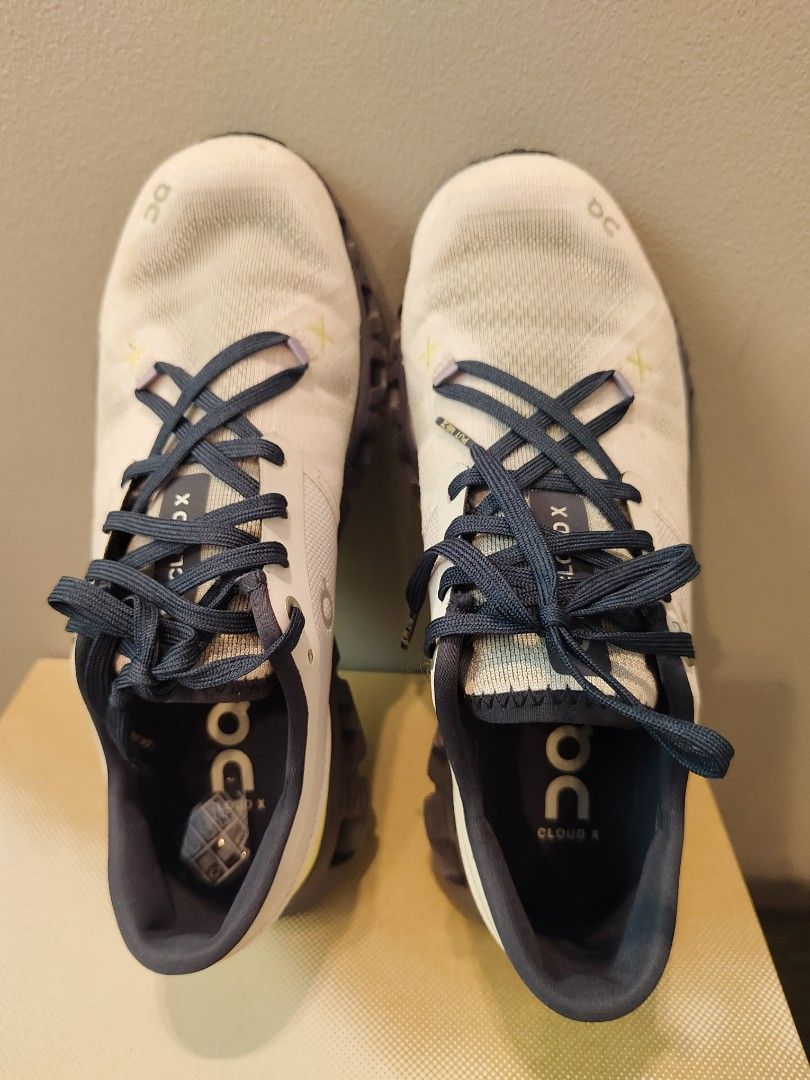 On Cloud X Running Shoes - US W7 (Category: Sneakers) located in Muntinlupa City. Submitted by cezzy82 (Listing ID 1422413320, Image 3). Description: On Cloud X running shoes in white, grey, and navy blue. US W7, EU 38, JP 24. Includes original box. Some sole wear. FLAWS: dirt only sign of usage no damage.