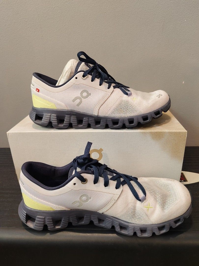On Cloud X Running Shoes - US W7 (Category: Sneakers) located in Muntinlupa City. Submitted by cezzy82 (Listing ID 1422413320, Image 2). Description: On Cloud X running shoes in white, grey, and navy blue. US W7, EU 38, JP 24. Includes original box. Some sole wear. FLAWS: dirt only sign of usage no damage.
