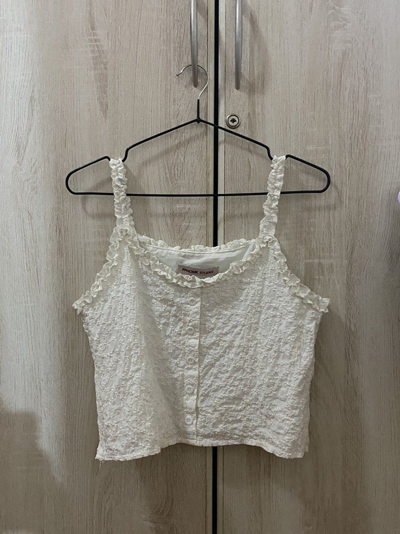 PPHOME STUDIO White Sleeveless Ruffle Coquette Top (Category: Sleeveless) located in Manila. Submitted by anneeem (Listing ID 1422393252, Image 2). Description: - PPHOME STUDIO white top - Textured fabric - Ruffle details on straps and neckline - Sleeveless - Cropped style - Zipper side.
