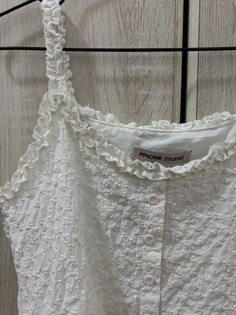 PPHOME STUDIO White Sleeveless Ruffle Coquette Top (Category: Sleeveless) located in Manila. Submitted by anneeem (Listing ID 1422393252, Image 3). Description: - PPHOME STUDIO white top - Textured fabric - Ruffle details on straps and neckline - Sleeveless - Cropped style - Zipper side.