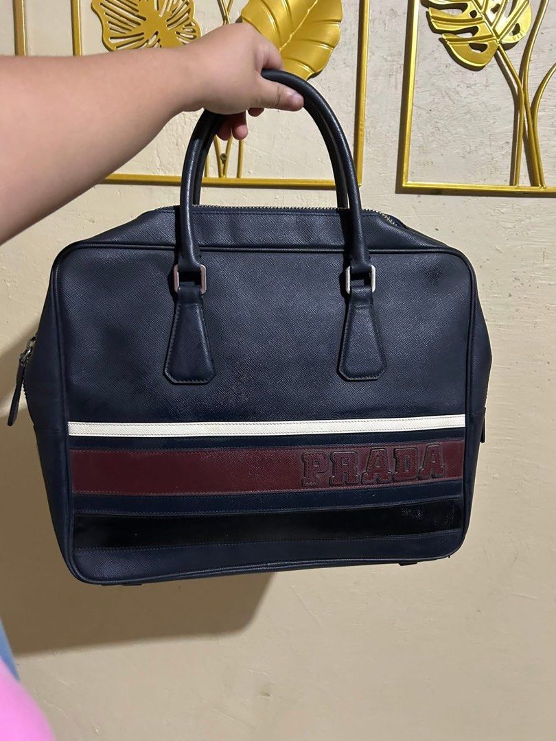 Prada Briefcase (Category: Luxury Bags & Wallets) located in Manila. Submitted by nicebag90 (Listing ID 1422482334, Image 1). Description: - Prada briefcase in navy blue - Striped design - Top handle - Zipper closure - Interior zipper pocket - Prada logo tag - Made in Italy - Spacious interior.