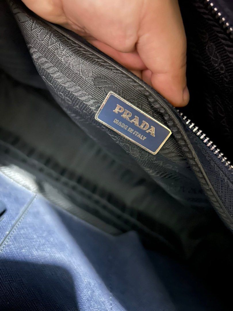 Prada Briefcase (Category: Luxury Bags & Wallets) located in Manila. Submitted by nicebag90 (Listing ID 1422482334, Image 2). Description: - Prada briefcase in navy blue - Striped design - Top handle - Zipper closure - Interior zipper pocket - Prada logo tag - Made in Italy - Spacious interior.