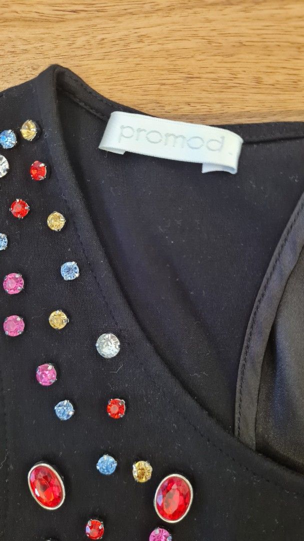 Promod Bejeweled Black Top (Category: Blouses) located in Cavite. Submitted by helpusdeclutter (Listing ID 1422543699, Image 3). Description: Promod Bejeweled Black Top Store bought. In great condition. Size XS. Color Black. with colorful embellishments around the neckline. All complete. Keyhole back with bow detail A-line cut Suitable for casual or semi-formal occasions Selling for P500 only!.