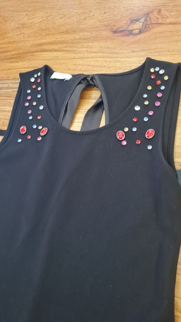 Promod Bejeweled Black Top (Category: Blouses) located in Cavite. Submitted by helpusdeclutter (Listing ID 1422543699, Image 2). Description: Promod Bejeweled Black Top Store bought. In great condition. Size XS. Color Black. with colorful embellishments around the neckline. All complete. Keyhole back with bow detail A-line cut Suitable for casual or semi-formal occasions Selling for P500 only!.