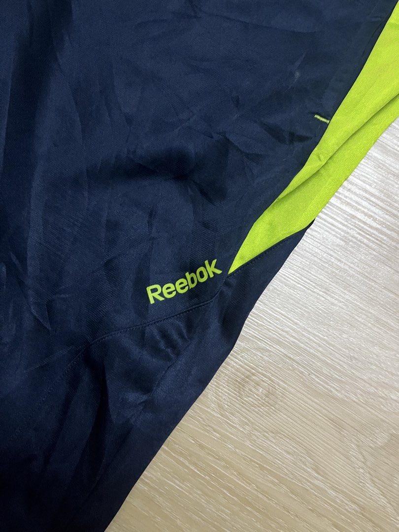 Reebok Fitness Division Track Pants (Category: Joggers) located in Klang. Submitted by aikall (Listing ID 1422503268, Image 2). Description: - Reebok track pants in navy blue with neon green accents. - Drawstring waist for adjustable fit. - Waist size: 30-36 inches. - Length: 40 inches. - Features Reebok Fitness Division logo. - Made of breathable material. - Perfect for workouts or casual wear..