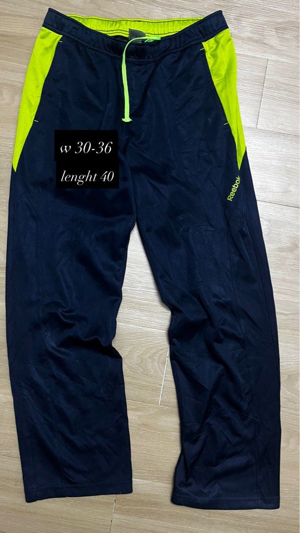 Reebok Fitness Division Track Pants (Category: Joggers) located in Klang. Submitted by aikall (Listing ID 1422503268, Image 1). Description: - Reebok track pants in navy blue with neon green accents. - Drawstring waist for adjustable fit. - Waist size: 30-36 inches. - Length: 40 inches. - Features Reebok Fitness Division logo. - Made of breathable material. - Perfect for workouts or casual wear..