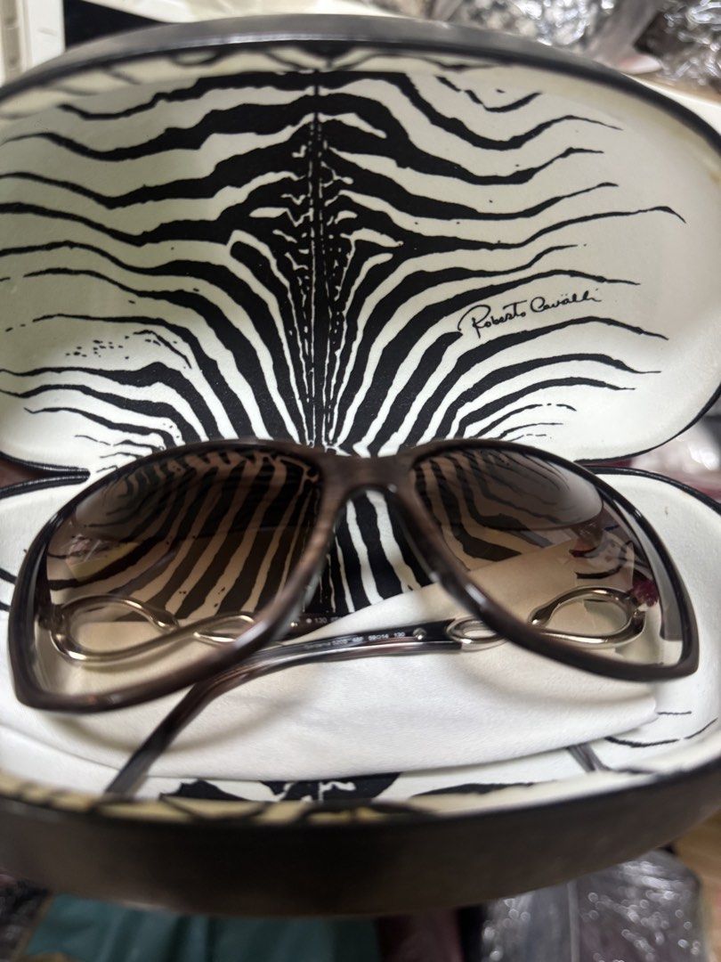Roberto Cavalli Sunglasses (Category: Sunglasses & Eyewear) located in Tarlac. Submitted by declutter_queen_e (Listing ID 1422407395, Image 2). Description: -With receipt (P18,000) - Authentic Roberto Cavalli sunglasses - Brown frame with a unique design - Comes with the original Roberto Cavalli case - Gradient lenses - Purchased from L.G. Pascual Optical -STORED ONLY / NEVER USED.