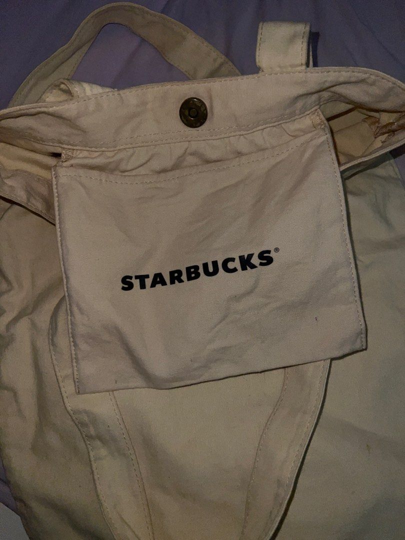 Starbucks Canvas Tote Bag (Category: Tote Bags) located in Cavite. Submitted by cssndrakateg (Listing ID 1422445090, Image 3). Description: - Starbucks canvas tote bag - Beige color - Starbucks logo on the front - Includes an inner pocket - Two handles for carrying.