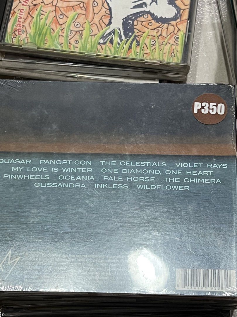 The Smashing Pumpkins Oceania CD (Category: CDs & DVDs) located in Pasig City. Submitted by itsmejaypee25 (Listing ID 1422506295, Image 2). Description: Smashing Pumpkins' album "Oceania" on CD. Features tracks like "Quasar", "Panopticon", and "The Celestials". Includes a sticker promoting their concert at the Smart Araneta Coliseum..