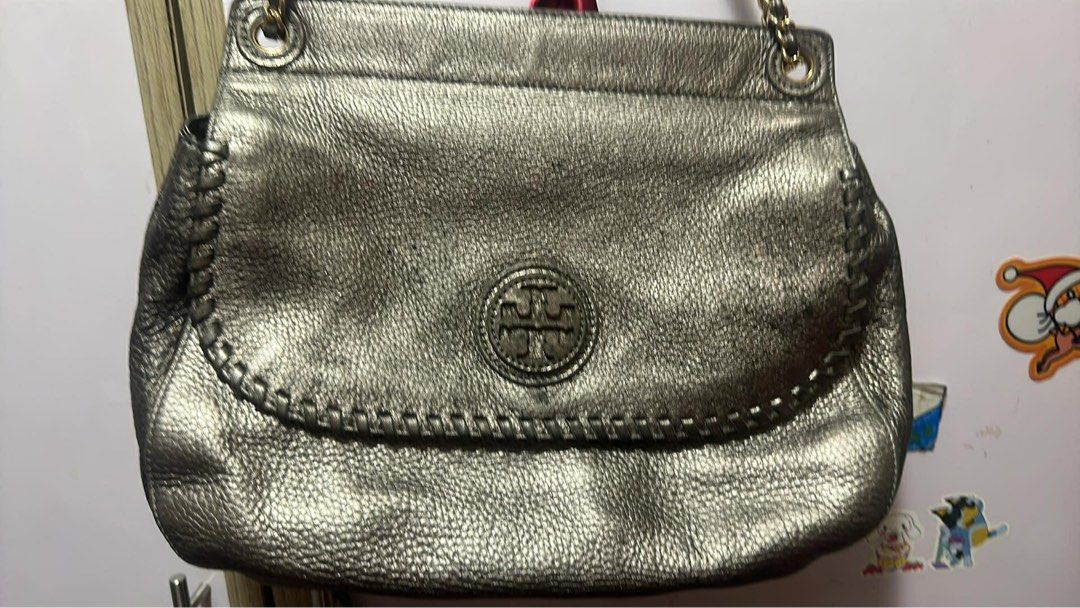 Tory Burch Metallic Handbag (Category: Luxury Bags & Wallets) located in Manila. Submitted by cecillepu56867 (Listing ID 1422466480, Image 1). Description: - Metallic handbag - Flap closure - Interior: zippered pocket, logo lining - Gold-toned zipper and hardware - Clean interior - Textured exterior.