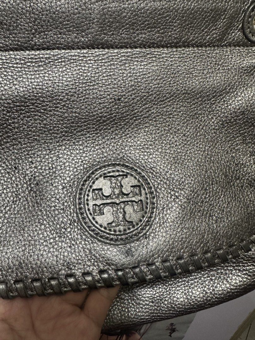 Tory Burch Metallic Handbag (Category: Luxury Bags & Wallets) located in Manila. Submitted by cecillepu56867 (Listing ID 1422466480, Image 2). Description: - Metallic handbag - Flap closure - Interior: zippered pocket, logo lining - Gold-toned zipper and hardware - Clean interior - Textured exterior.