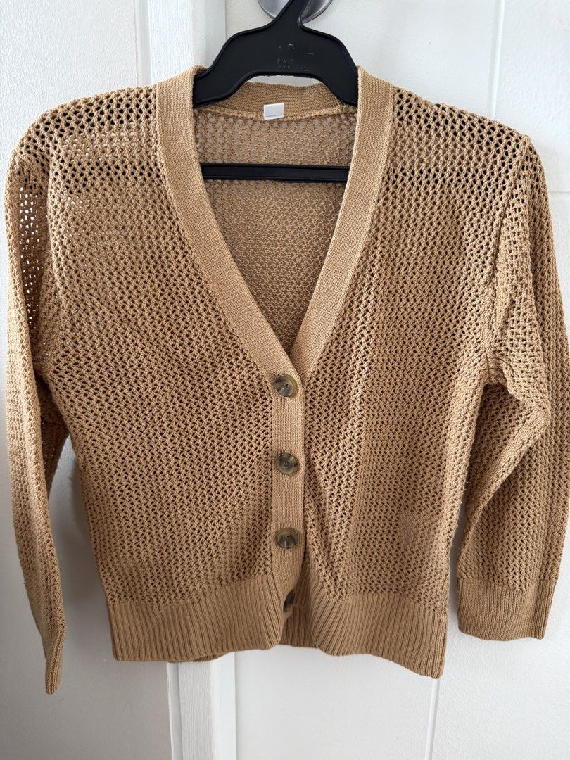 Uniqlo Open Knit Cardigan (Category: Coats, Jackets and Outerwear) located in Taguig. Submitted by BellaC (Listing ID 1422408585, Image 1). Description: - Uniqlo tan cardigan - Open knit design - V-neckline - Button-down closure - Long sleeves - Ribbed hem and cuffs - Size 120 (kids) - Perfect for layering.