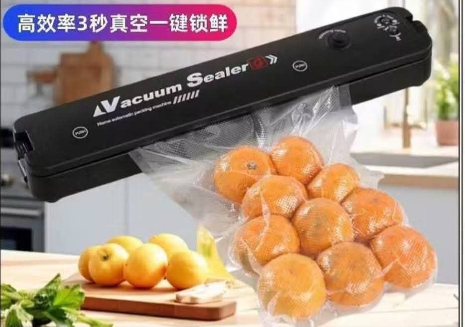 Vacuum Sealer (Category: Other Home Appliances) located in Manila. Submitted by jelai.cybyb (Listing ID 1422504193, Image 2). Description: Vacuum sealer is designed for home use. It can seal various food items, including sausages, oranges, and meat. The sealer is suitable for dry, wet, oil, and powder applications. The images show it can quickly seal items..