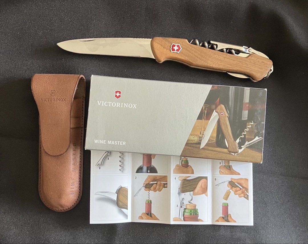 VICTORINOX Wine Master Walnut (Category: Knives & Chopping Boards) located in Paranaque City. Submitted by d33t00 (Listing ID 1422464196, Image 3). Description: Victorinox Wine Master is a multi-tool designed for wine enthusiasts. It features a wooden handle, a corkscrew, a blade, and a bottle opener. The set includes a leather pouch and a user's guide. It is a Red Dot Award winner from 2018. The item is in its original packaging. Brand new, with