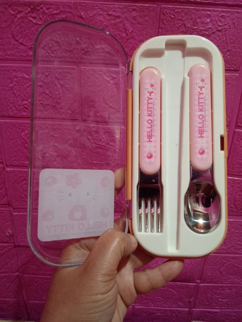 Vintage Hello Kitty Cutlery Set with Case (Category: Dinnerware & Cutlery) located in Bulacan. Submitted by renasophiatoystore2020 (Listing ID 1422423065, Image 2). Description: - Kitty cutlery set - Includes fork, spoon, and case - Features a pink and white design - Clear and orange case - Pink cutlery handles with Kitty graphics - Unused condition.