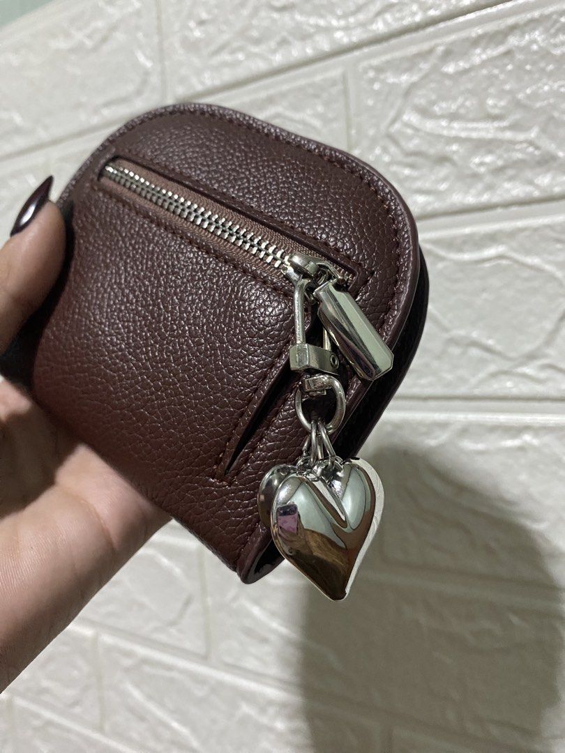 Wallet Coin Purse (Category: Wallets & Card holders) located in Manila. Submitted by missthrift___ (Listing ID 1422470881, Image 2). Description: Coin purse features a dark brown exterior with a zipper closure. It has a silver heart charm attached. Inside, there are multiple card slots. The purse is secured with a snap closure. bought for 235 pesos .