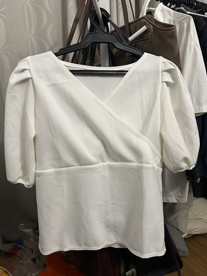 White Wrap Blouse (Category: Blouses) located in Marikina City. Submitted by fm.ty (Listing ID 1422472463, Image 1). Description: White wrap blouse with V-neck and puffed sleeves. Fitted waist, flowing fabric. Great for casual or semi-formal wear. Pairs well with skirts or pants..