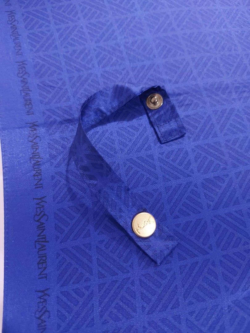 YSL Blue Umbrella (Category: Umbrellas) located in Bayombong. Submitted by Gentlemans_ClosEt (Listing ID 1422484732, Image 2). Description: - YSL umbrella - Vibrant blue color - Unique geometric pattern - Snap closure - Gold-colored handle accent - Includes tag with Japanese characters - Compact, foldable design - Stylish accessory for rainy days.