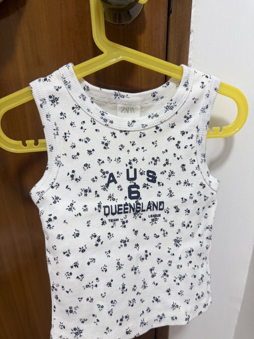 Zara Floral Tank Top (Category: Babies & Kids Fashion) located in Manila. Submitted by eah0416 (Listing ID 1422401146, Image 1). Description: - Zara floral tank top - Size: 6-7 years - Features: - Round neckline - Sleeveless - "AUS 6 QUEENSLAND TEAM LEAGUE" print - Material: Made in Turkey.