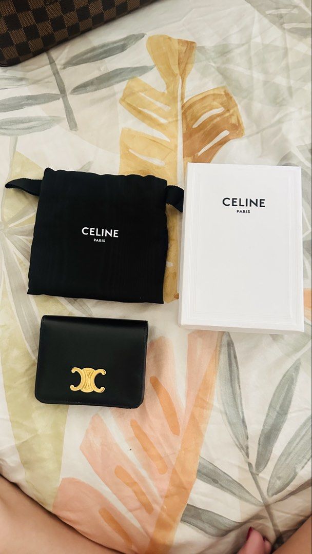 Authentic Celine Triomphe Wallet (Category: Luxury Bags & Wallets) located in Pasig City. Submitted by boxfulgoodies (Listing ID 1422618242, Image 2). Description: - Authentic Celine Triomphe card holder - Color: Black - Features gold-tone Triomphe logo - Includes original box, dust bag, and care card - Interior: Multiple card slots and zippered compartment - Made in Italy - Bought for 39,500 - Super good deal with its condition.