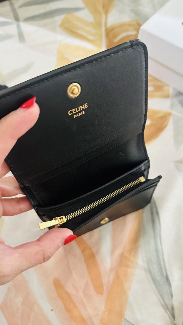 Authentic Celine Triomphe Wallet (Category: Luxury Bags & Wallets) located in Pasig City. Submitted by boxfulgoodies (Listing ID 1422618242, Image 3). Description: - Authentic Celine Triomphe card holder - Color: Black - Features gold-tone Triomphe logo - Includes original box, dust bag, and care card - Interior: Multiple card slots and zippered compartment - Made in Italy - Bought for 39,500 - Super good deal with its condition.