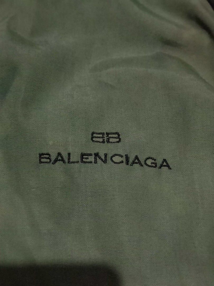 Vtg Balenciaga Hooded (removable Jacket (Category: Coats, Jackets and Outerwear) located in Reina Mercedes. Submitted by SIRCHIVES (Listing ID 1422623088, Image 3). Description: - Balenciaga hooded jacket - Color: Green with black accents - Size: 5 (Xl) - Features: Hood, front zipper, Balenciaga logo - Material: 100% nylon outer shell, 100% polyester lining - Style number: BJ90645-49.