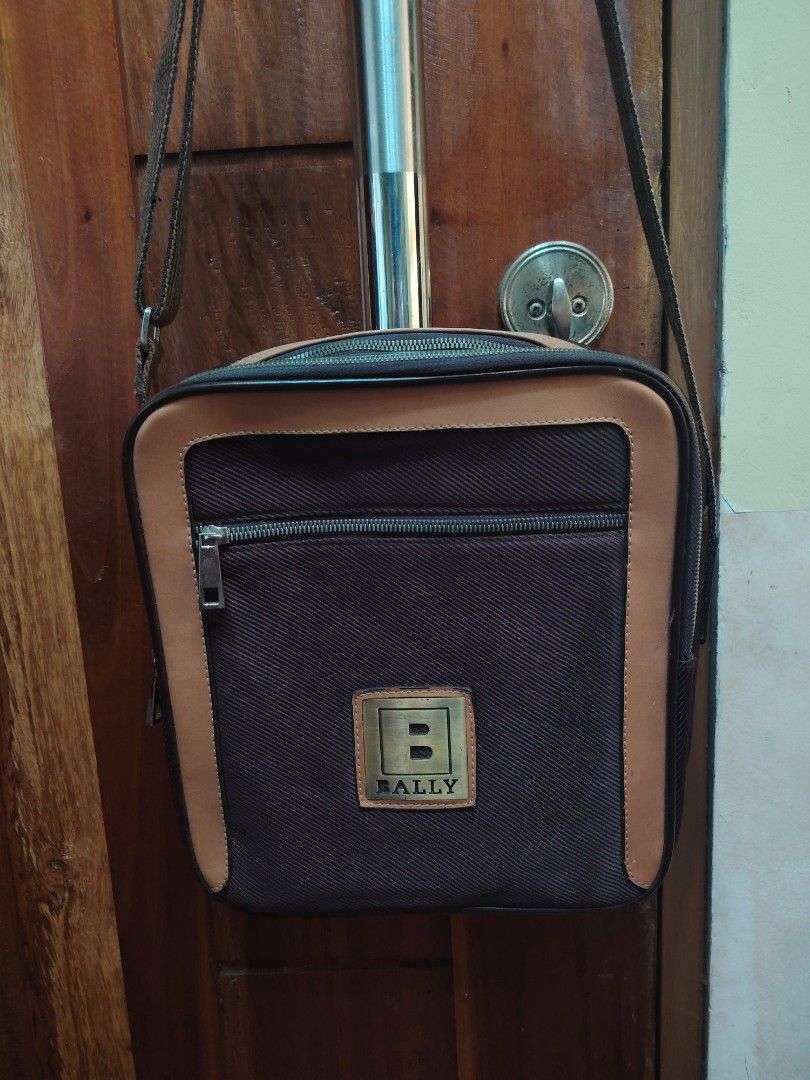 Bally Crossbody Bag (Category: Luxury Bags & Wallets) located in Bulacan. Submitted by branded_murayta (Listing ID 1422616717, Image 2). Description: - Vintage Bally crossbody bag - Brown textured fabric body - Tan leather trim - Front zippered pocket - Top zipper closure - Gold-tone "B" logo plaque - Striped brown and tan strap - Interior leather tag with Bally logo *preloved market value: 3k to 12k pesos 😮.