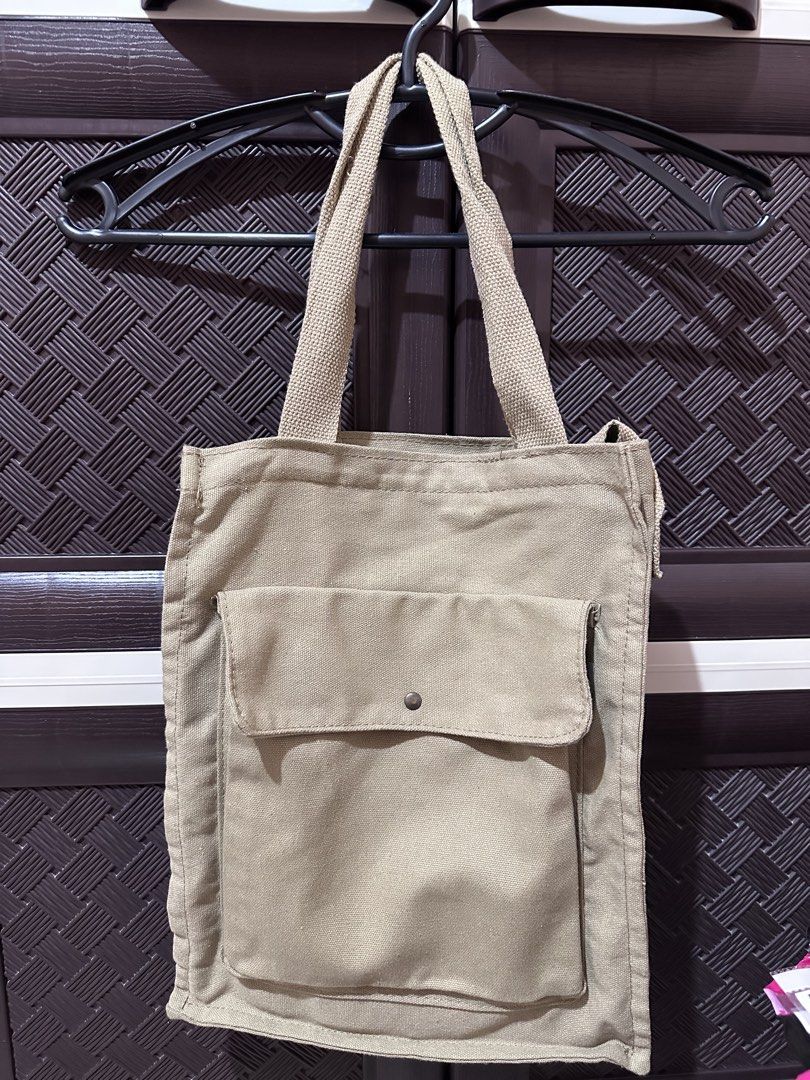 Beige Canvas Tote Bag with Front Pocket (Category: Tote Bags) located in Pila. Submitted by airrapreloved_ (Listing ID 1422657958, Image 2). Description: ✔️ Good condition ✔️ Thick canvas material ✔️ With front pocket and snap button ✔️ Spacious – kasya books, tablet, wallet, essentials.