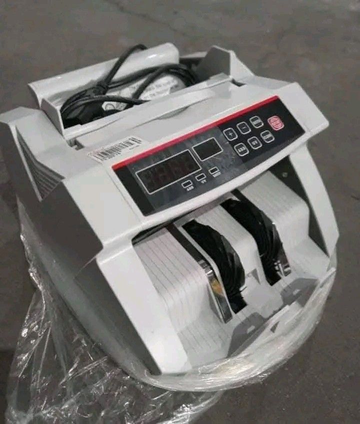 Bill Counter with LED Display (Category: Office & Business Technology) located in Makati City. Submitted by oideme (Listing ID 1422578447, Image 1). Description: Bill counter features an LED display and is designed for efficient currency counting. It has multiple buttons for various functions. The dimensions are approximately 11.81" x 10" x 6.89". The back of the device has a power switch and a port. It comes in its original packaging..