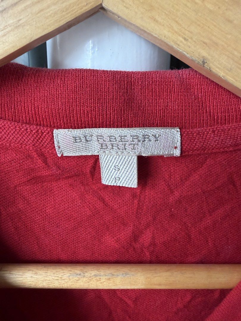 Burberry Brit Red Polo Shirt (Category: Tshirts & Polo Shirts ) located in Luna. Submitted by shoppesmith2020 (Listing ID 1422640952, Image 2). Description: - Burberry Brit red polo shirt - Size: S - Classic polo collar - Short sleeves - Button-down placket - Burberry Brit logo detail - Decorative sleeve trim.