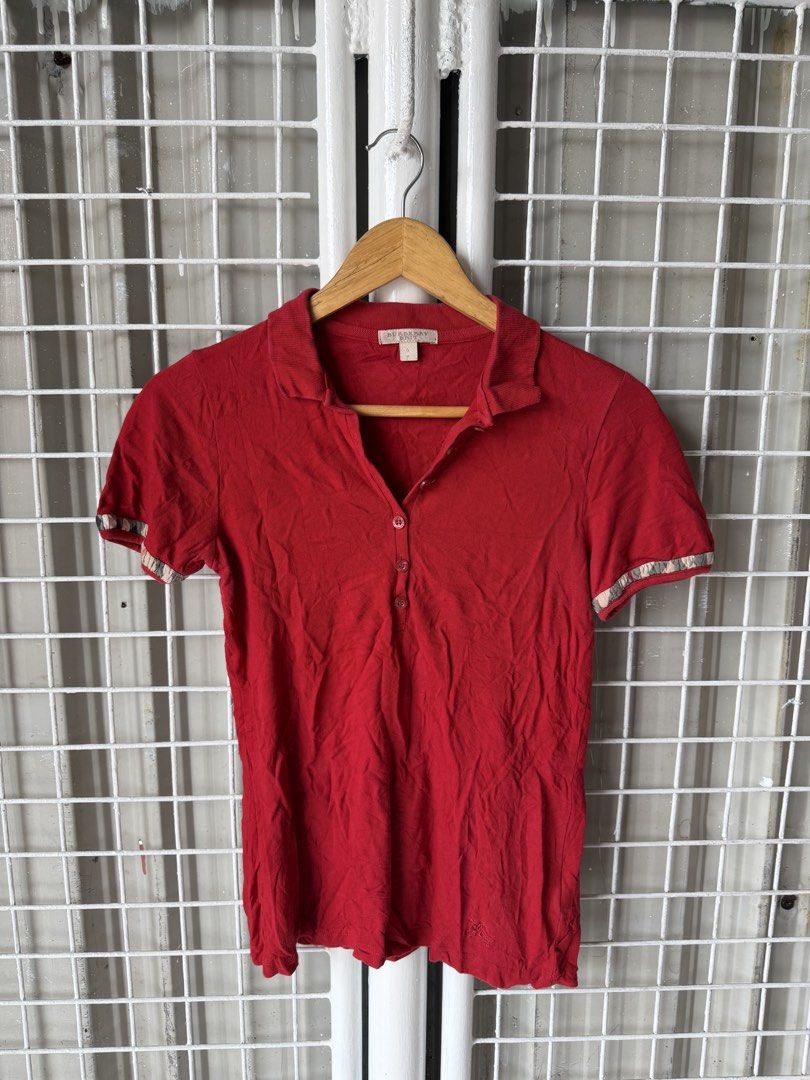 Burberry Brit Red Polo Shirt (Category: Tshirts & Polo Shirts ) located in Luna. Submitted by shoppesmith2020 (Listing ID 1422640952, Image 1). Description: - Burberry Brit red polo shirt - Size: S - Classic polo collar - Short sleeves - Button-down placket - Burberry Brit logo detail - Decorative sleeve trim.