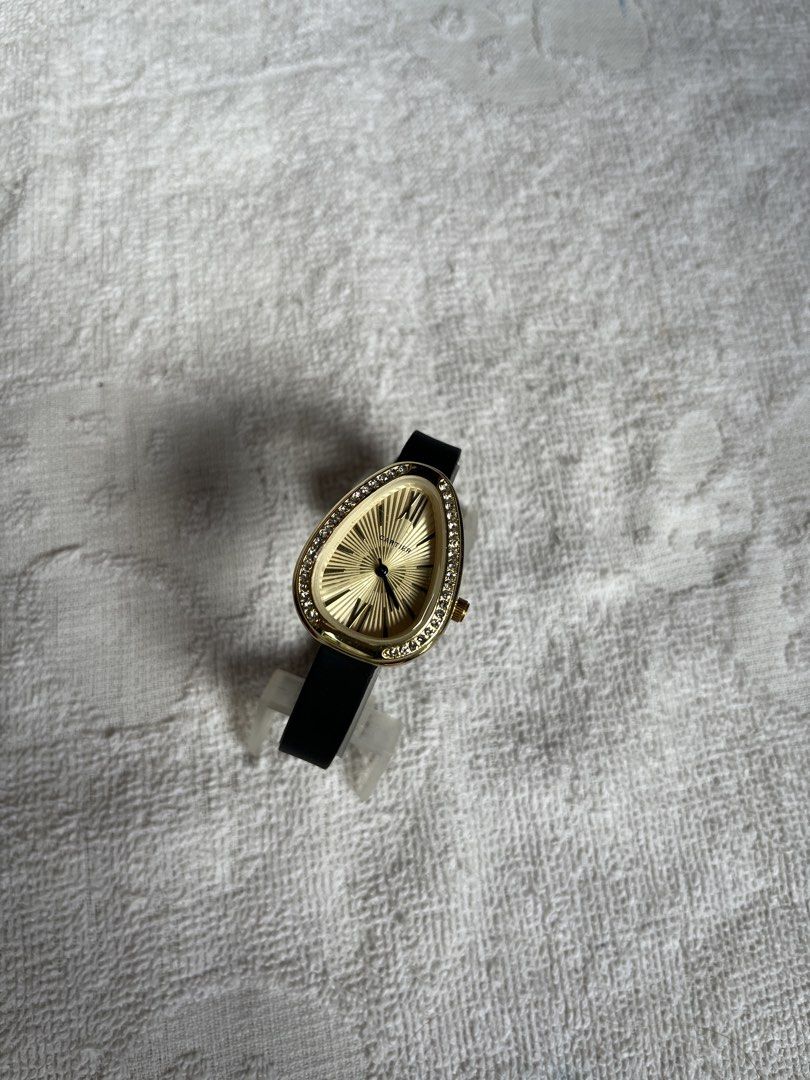 Cartier Ladies Watch (Category: Luxury Watches) located in Manila. Submitted by cddygods (Listing ID 1422559883, Image 2). Description: - Cartier ladies watch - Unique teardrop-shaped face - Gold-toned dial - Black strap - Red Cartier box included - Gold-colored bezel with embedded crystals - Gold-toned back with Cartier logo.