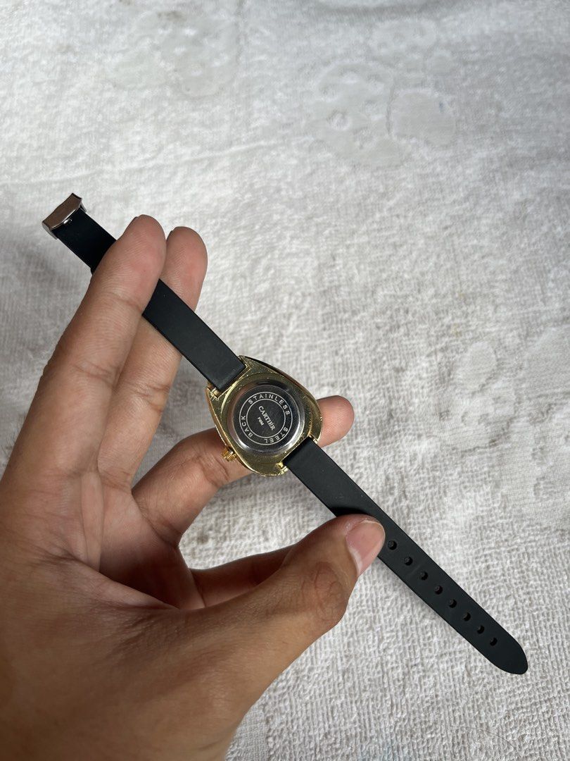 Cartier Ladies Watch (Category: Luxury Watches) located in Manila. Submitted by cddygods (Listing ID 1422559883, Image 3). Description: - Cartier ladies watch - Unique teardrop-shaped face - Gold-toned dial - Black strap - Red Cartier box included - Gold-colored bezel with embedded crystals - Gold-toned back with Cartier logo.