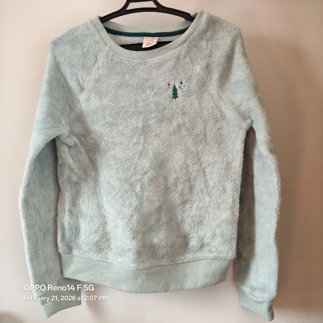 Cat & Jack Sleepwear Sweatshirt - Size L (Category: Longsleeves) located in Santa Rosa. Submitted by secondglancemanila (Listing ID 1422593830, Image 1). Description: Cozy Cat & Jack sleepwear sweatshirt in a light blue color. Features a small embroidered Christmas tree design on the front. It has a round neckline with a dark green trim. The size is L (10/12). Fits 10y.o. kid.