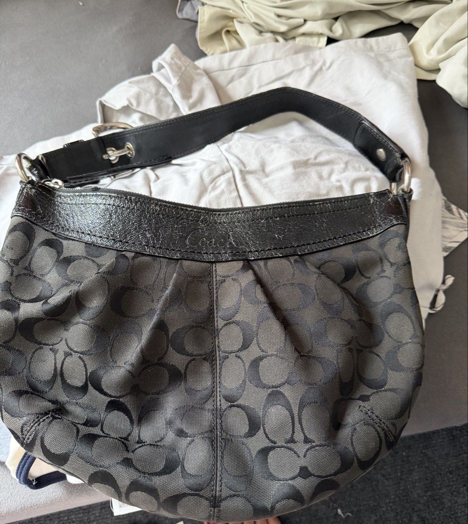 Coach Black Shoulder Bag (Category: Luxury Bags & Wallets) located in Manila. Submitted by k.123478 (Listing ID 1422705875, Image 1). Description: Vintage Coach Signature C - Black Coach shoulder bag - Signature pattern - Curved design - Leather trim and strap - Zipper closure - Silver-tone hardware - Minor wear on leather PRICE IS NEGO.