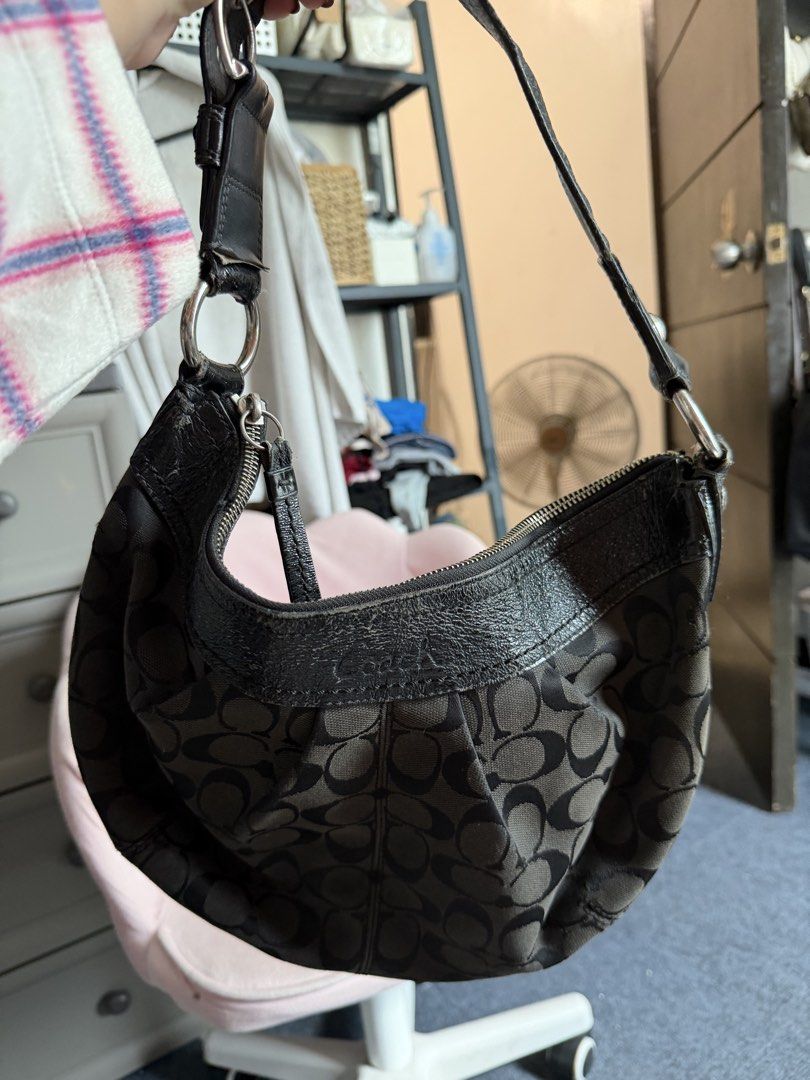 Coach Black Shoulder Bag (Category: Luxury Bags & Wallets) located in Manila. Submitted by k.123478 (Listing ID 1422705875, Image 2). Description: Vintage Coach Signature C - Black Coach shoulder bag - Signature pattern - Curved design - Leather trim and strap - Zipper closure - Silver-tone hardware - Minor wear on leather PRICE IS NEGO.