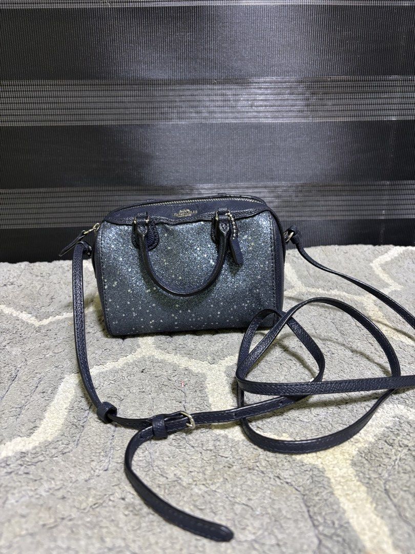 Coach Glitter Mini Satchel Crossbody Bag (Category: Luxury Bags & Wallets) located in Pasay City. Submitted by irishl (Listing ID 1422567574, Image 1). Description: - Coach mini satchel with a glittery finish - Includes a crossbody strap and dual top handles - Secure top zipper closure - Interior in a solid color - Adorned with gold-toned hardware - Comes with a small Coach tag - Ideal size for carrying essentials.