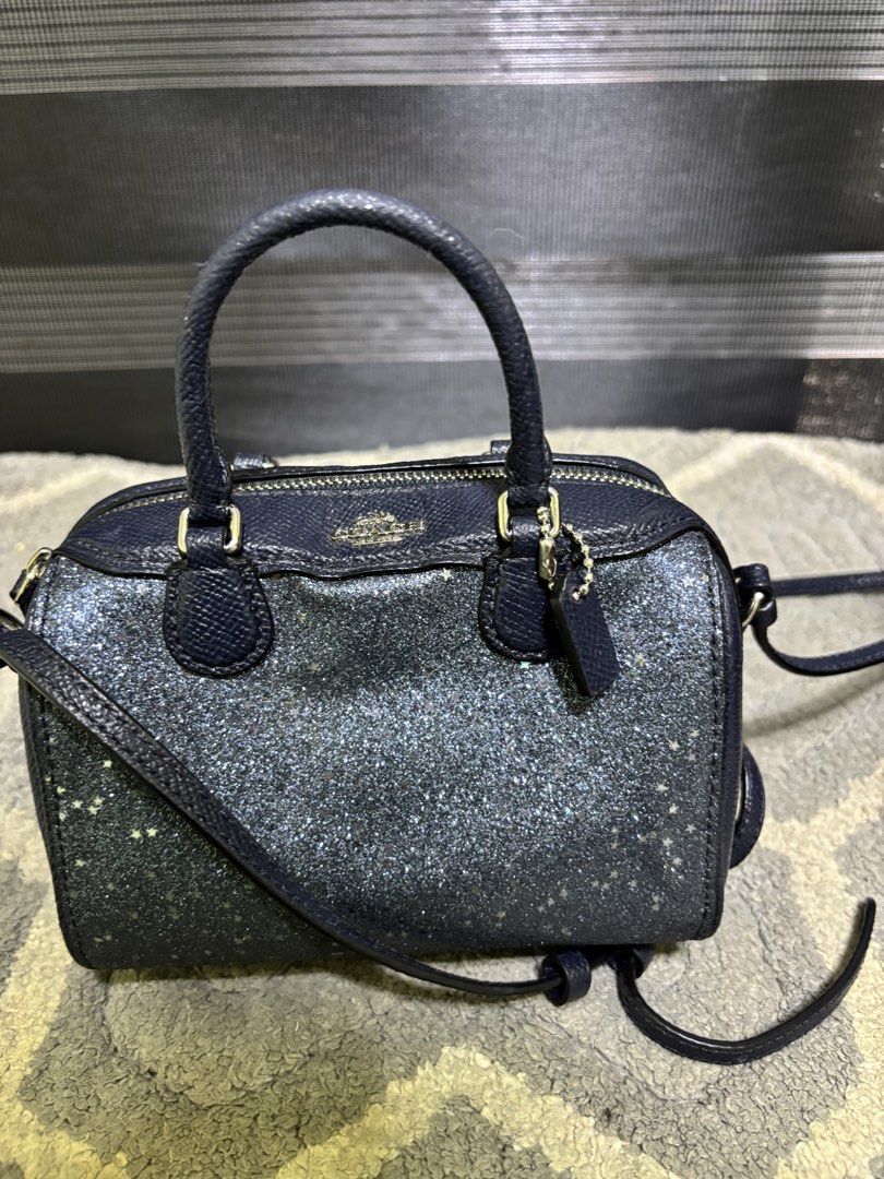 Coach Glitter Mini Satchel Crossbody Bag (Category: Luxury Bags & Wallets) located in Pasay City. Submitted by irishl (Listing ID 1422567574, Image 3). Description: - Coach mini satchel with a glittery finish - Includes a crossbody strap and dual top handles - Secure top zipper closure - Interior in a solid color - Adorned with gold-toned hardware - Comes with a small Coach tag - Ideal size for carrying essentials.