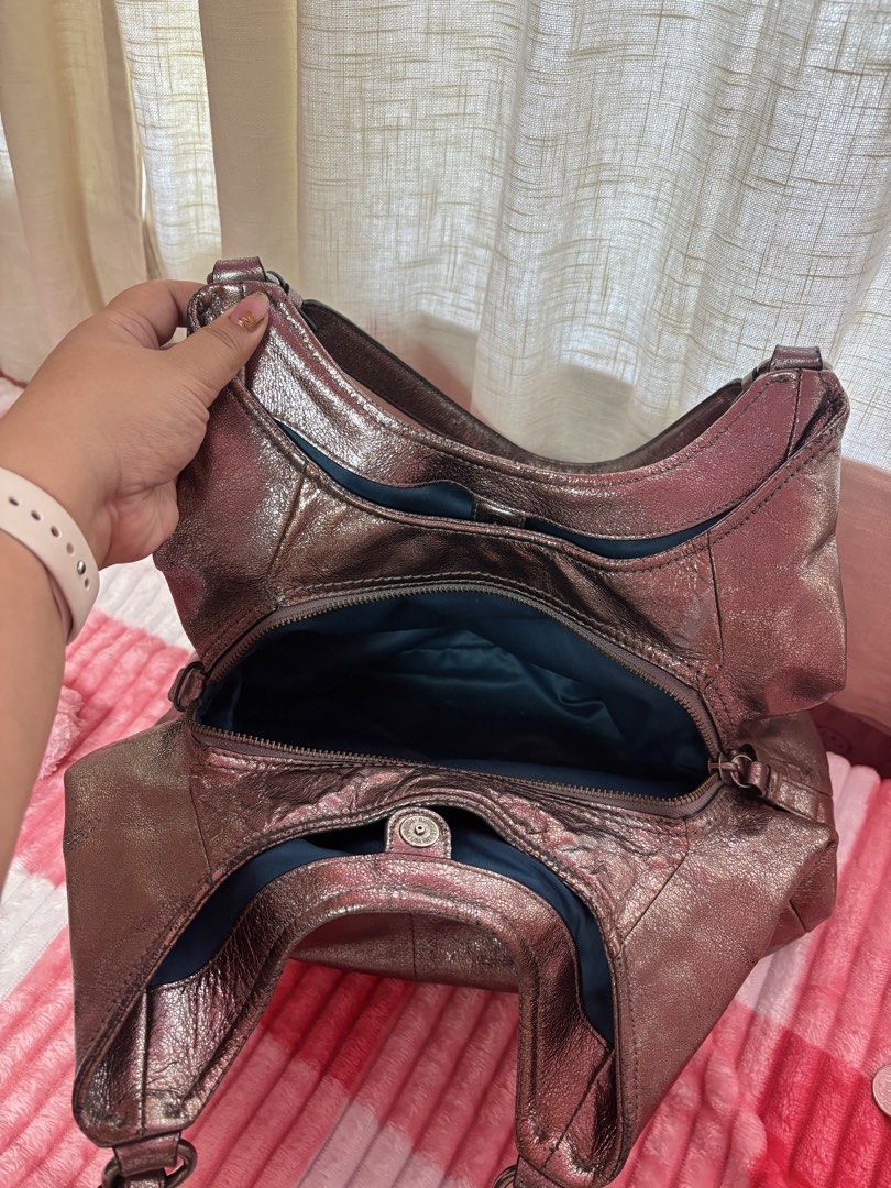 Authentic Coach Metallic Hobo Bag (Category: Luxury Bags & Wallets) located in Imus. Submitted by qwertynewb (Listing ID 1422547225, Image 2). Description: - Decluttering sale (need funds) -STILL IN GOOD CONDITION 8.5/10 -Metallic Coach hobo bag - Dual shoulder straps - Main compartment with zipper closure - Interior pocket - Teal interior lining - Includes Coach leather tag - Metallic finish - Buckle details on straps -GOOD DEAL NA PO ITO.