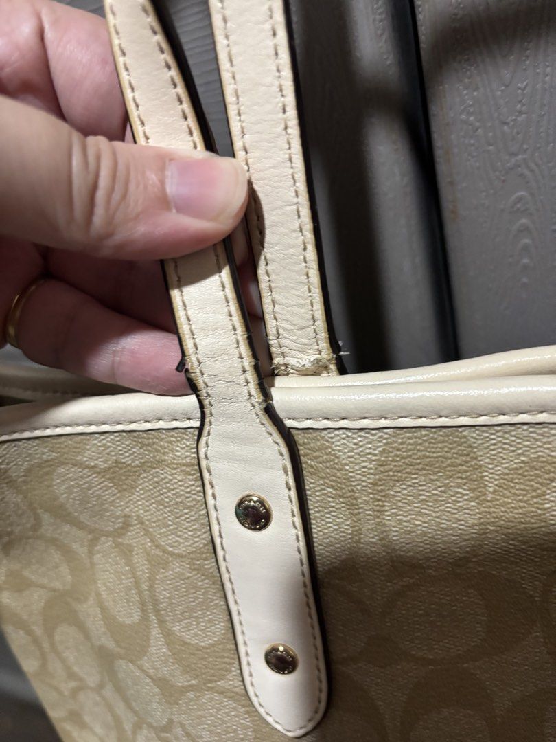 Coach Signature Tote Bag (Category: Luxury Bags & Wallets) located in Manila. Submitted by jjrdz (Listing ID 1422668428, Image 3). Description: - Coach tote bag - Signature pattern - Cream-colored handles and trim - Gold-tone hardware - Interior Coach label - Minor mark on exterior - Some wear on handles.