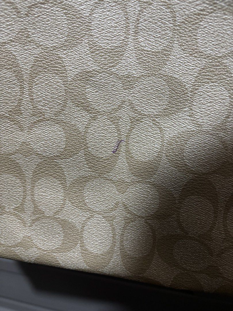 Coach Signature Tote Bag (Category: Luxury Bags & Wallets) located in Manila. Submitted by jjrdz (Listing ID 1422668428, Image 2). Description: - Coach tote bag - Signature pattern - Cream-colored handles and trim - Gold-tone hardware - Interior Coach label - Minor mark on exterior - Some wear on handles.