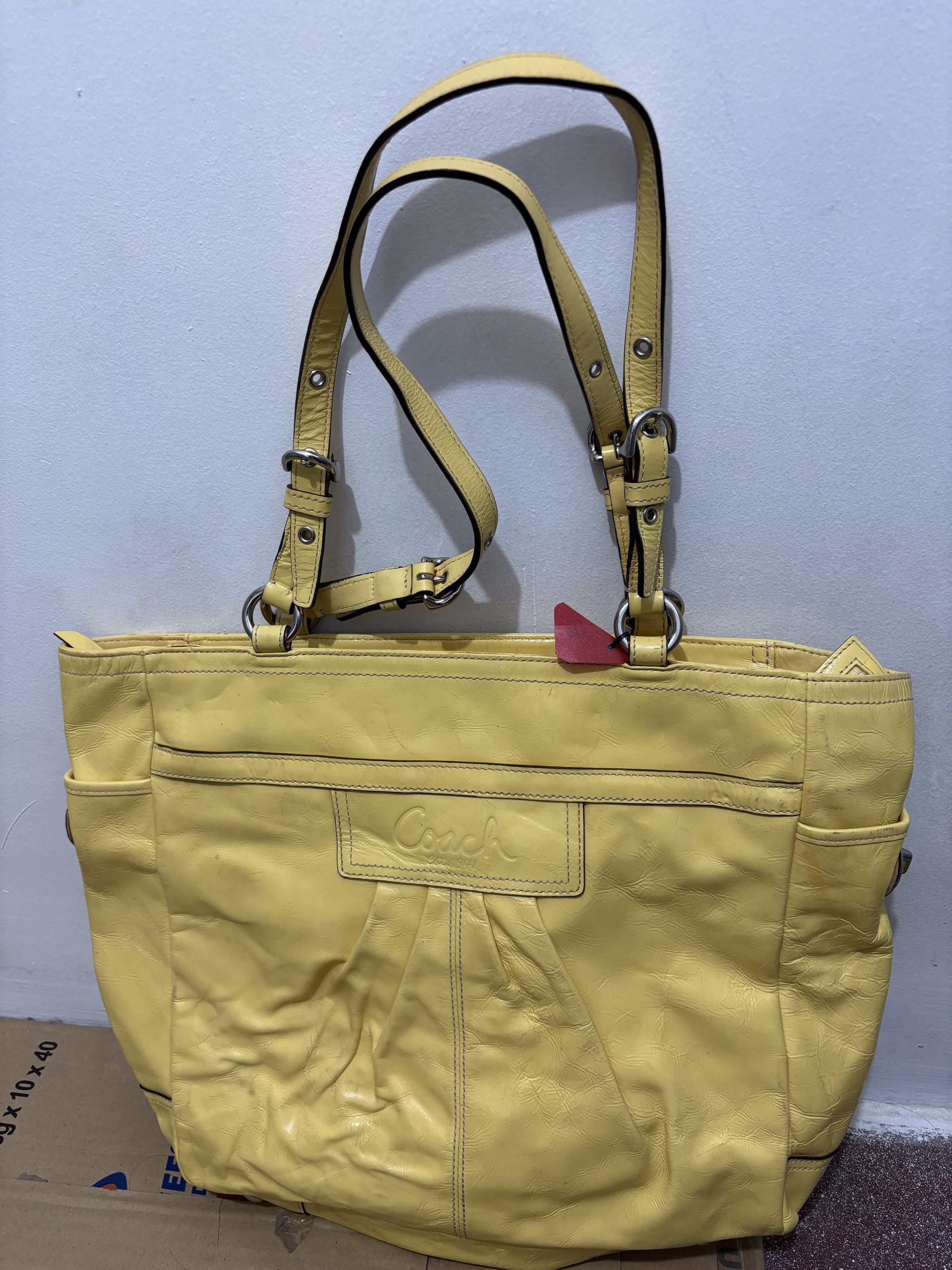Coach Yellow Leather Tote Bag (Category: Shoulder Bags) located in Taguig. Submitted by macxdinglas (Listing ID 1422566290, Image 1). Description: - Yellow Coach tote bag - Main compartment with zipper closure - Interior pocket - Two exterior side pockets - Embossed Coach logo - Double handles - Silver-tone hardware - Authentic Coach Naka ykk mga zipper Padala ng sister ko from US malinis loob walang sira.